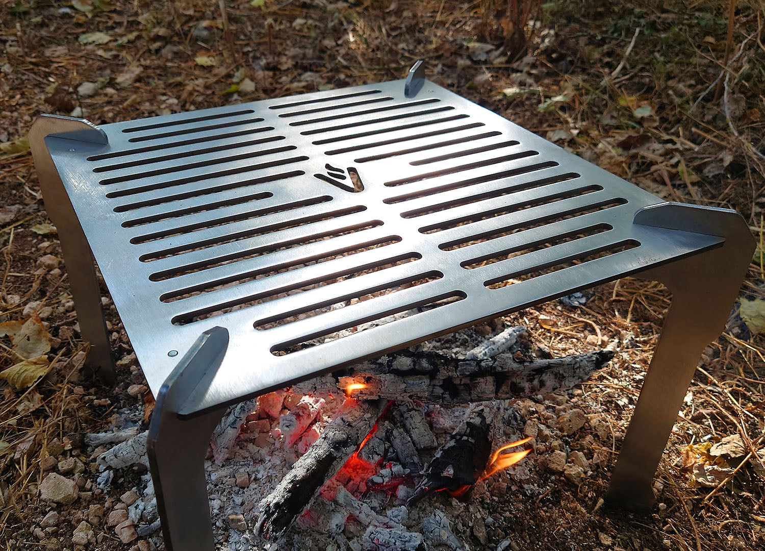 Volcann Ferox Open Fire Grill & Cooktop in an outdoor setting, closeup shot