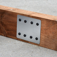 Closeup of the bracket used to secure the straight edges of the railway sleepers in rectangular planters.