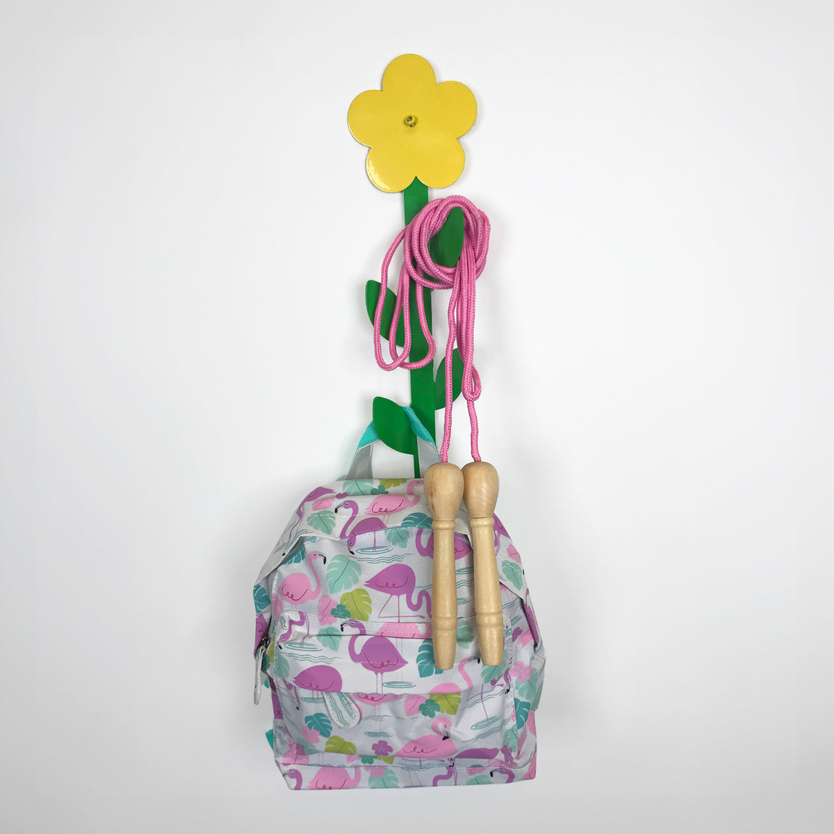 Coat Hook in the shape of a flower with a childrens rucksack and a skipping rope hanging from it.