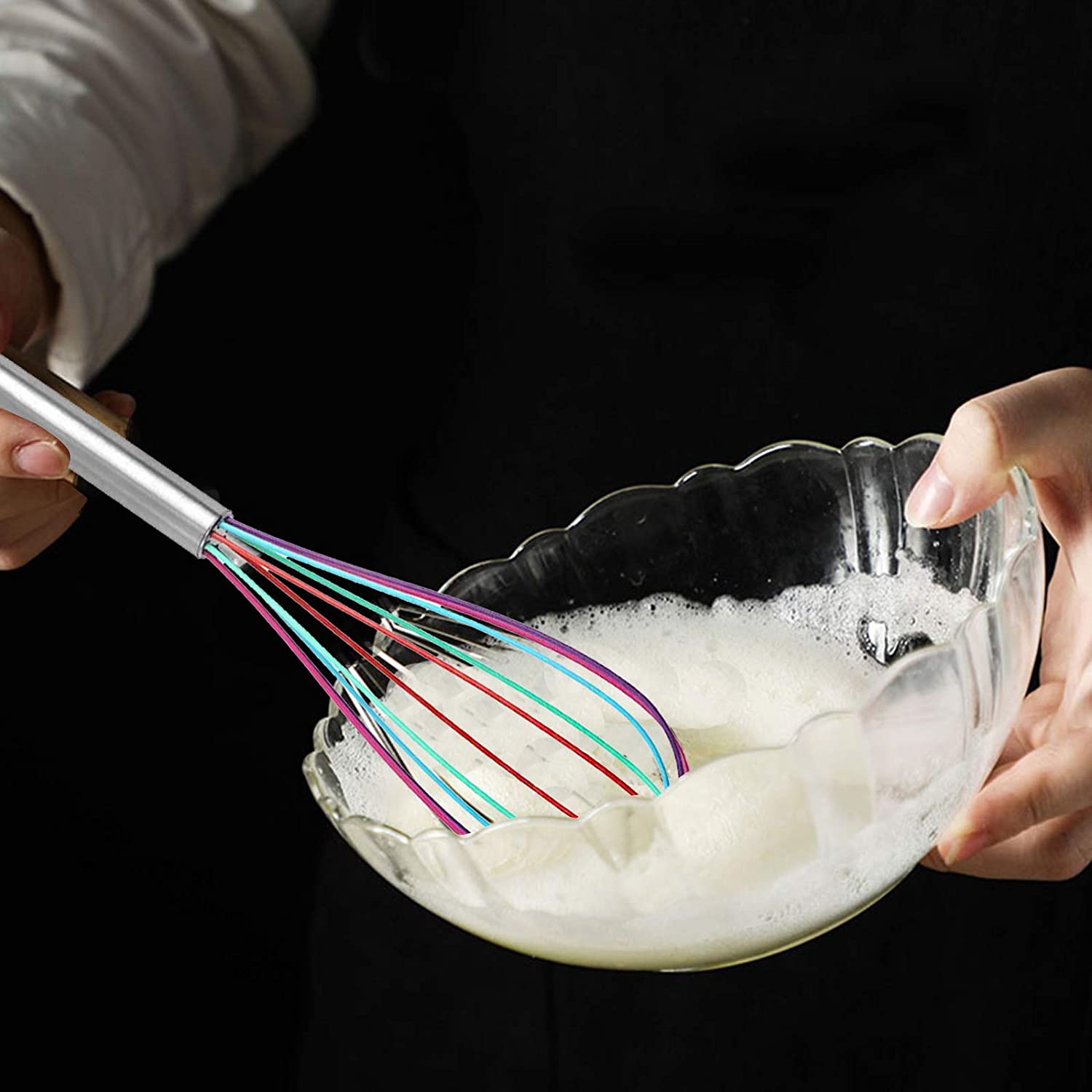 Whisk being used to froth milk for desserts