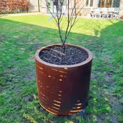 Closeup of the single planter, positioned in someone's garden