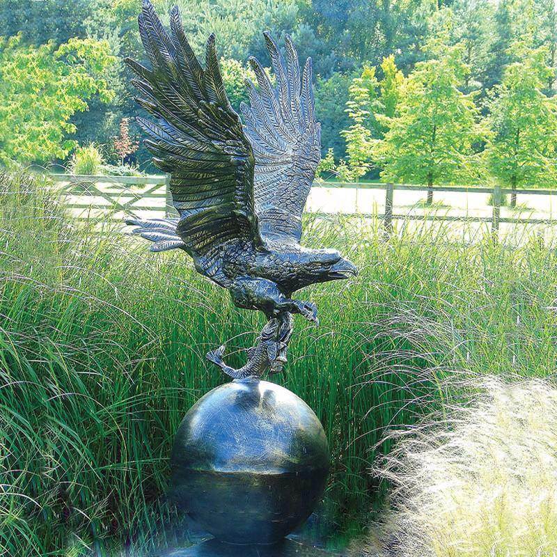 Bronze Eagle Standing On Ball Statue by Fergus McArthur