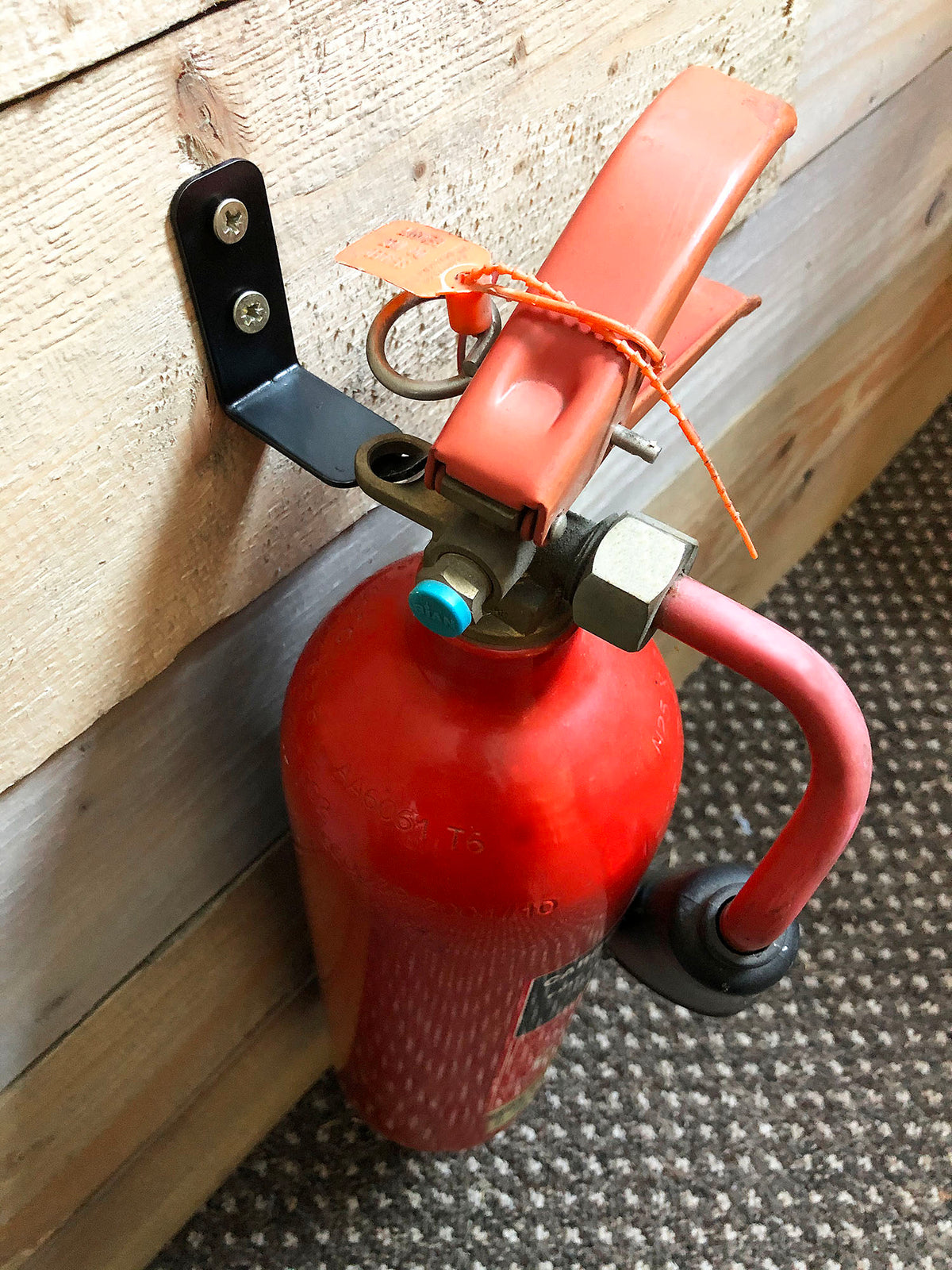 Wall Mount Fire Extinguisher Bracket installed in an office setting