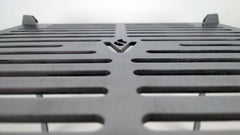 Closeup of the detailing on the cooktop showing the cutouts and the Volcann logomark