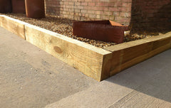 Timber Sleepers used to make driveway edging to keep stones off of the concrete surface