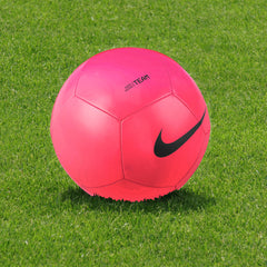 Nike Pitch Team Football - Bright Pink Finish - Ball Positioned on Turf on Modern Football Pitch