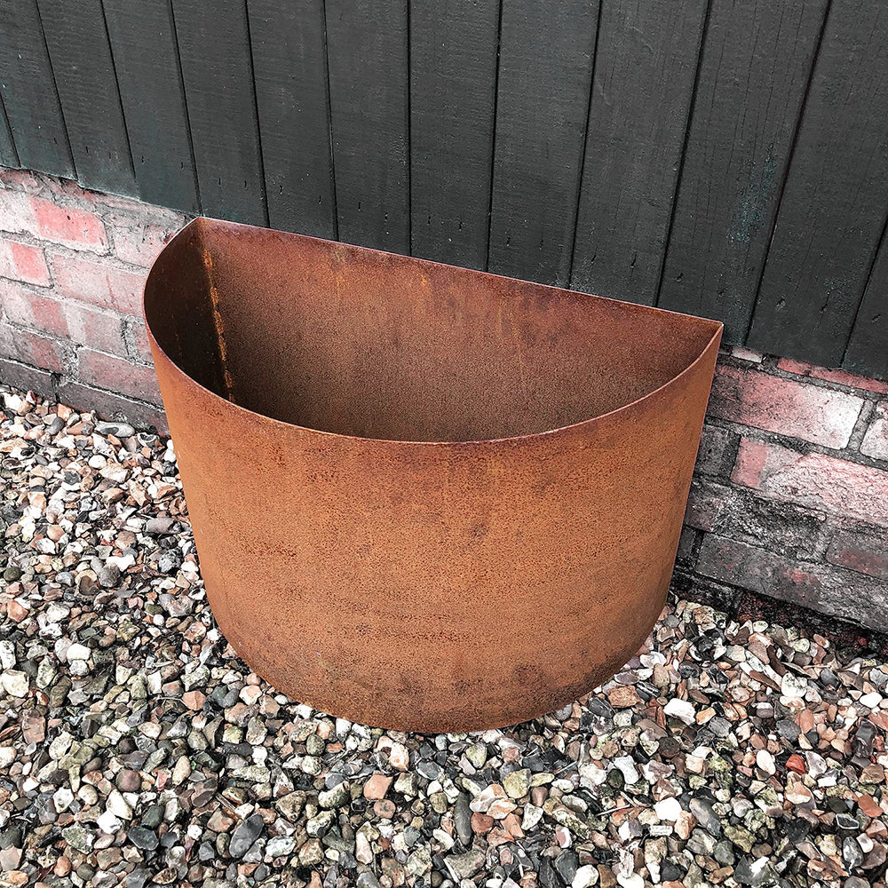 planter positioned against brick and wooden clad wall