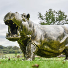 The Bronze Hippo Sculpture standing majestically in a garden setting