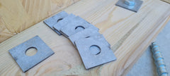 Square Washers on a plank of wood