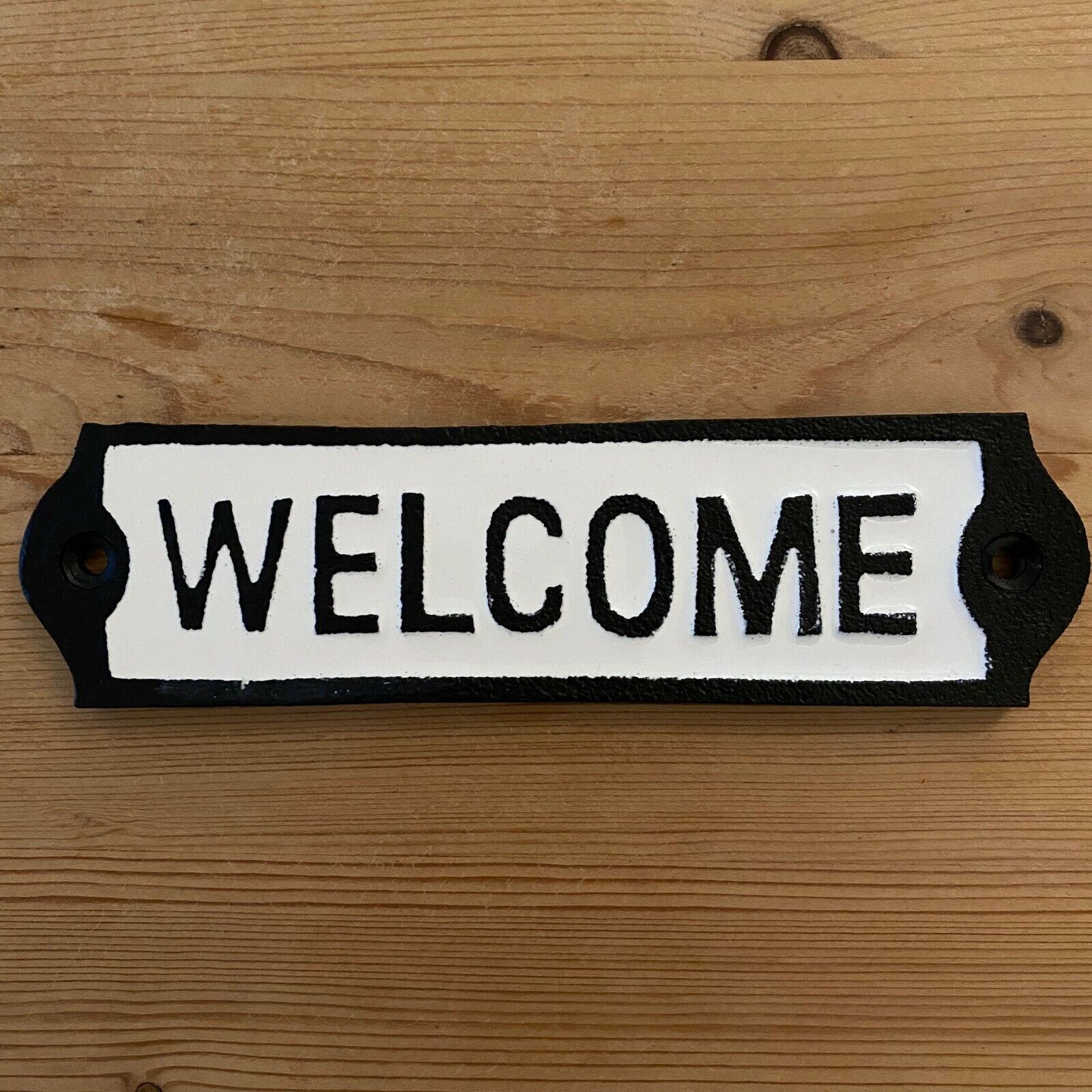 Closeup view of cast iron Welcome sign